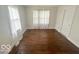 Neutral bedroom with hardwood floors and natural light from a large window at 237 Ringwood Way, Anderson, IN 46013