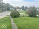 Well-maintained front yard with lush grass and mature trees in a quiet neighborhood at 237 Ringwood Way, Anderson, IN 46013