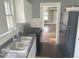 Galley kitchen featuring white cabinets, gas range and black refrigerator at 237 Ringwood Way, Anderson, IN 46013