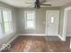 Inviting living room featuring a ceiling fan, natural light, and hardwood floors awaiting personal touches at 237 Ringwood Way, Anderson, IN 46013