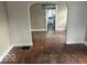 Spacious living room with hardwood floors and an archway leading to the kitchen at 237 Ringwood Way, Anderson, IN 46013