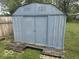 The property features a large, blue storage shed with double doors and a wooden base at 237 Ringwood Way, Anderson, IN 46013