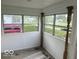 Bright sun room with beadboard walls, wooden posts, and multiple windows at 237 Ringwood Way, Anderson, IN 46013