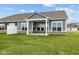Exterior view of home with a covered patio, white pillars, well manicured lawn and neutral siding at 3544 Wrangler Dr, Bargersville, IN 46106