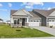 Charming home featuring a two-car garage, stone accents, manicured lawn, and a welcoming front porch at 3544 Wrangler Dr, Bargersville, IN 46106