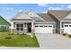 Charming home featuring a two-car garage, stone accents, manicured lawn, and a welcoming front porch at 3544 Wrangler Dr, Bargersville, IN 46106