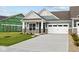 Charming home featuring a two-car garage, stone accents, manicured lawn, and a welcoming front porch at 3544 Wrangler Dr, Bargersville, IN 46106