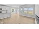 Open-concept living space with wood-look floors, lots of natural light, and a fireplace at 3544 Wrangler Dr, Bargersville, IN 46106