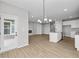 Open-concept living area featuring a fireplace, kitchen with a center island, and access to the backyard at 3544 Wrangler Dr, Bargersville, IN 46106