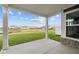 Covered patio showcasing stone supports, concrete floors, and a spacious backyard with a partial view of the neighborhood at 3544 Wrangler Dr, Bargersville, IN 46106