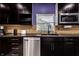 Well-lit kitchen with dark wood cabinets, stainless steel appliances, and modern fixtures at 6572 S 300 W, Trafalgar, IN 46181