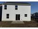 Exterior shot featuring a simple backyard with white siding and a patio at 11015 Walter Dr, Indianapolis, IN 46235