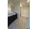 Bathroom boasts a double vanity with granite counters, a spacious shower and wood-look vinyl floors at 11015 Walter Dr, Indianapolis, IN 46235