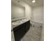 Contemporary bathroom features a double sink vanity, large mirror, and shower-tub combo at 11015 Walter Dr, Indianapolis, IN 46235