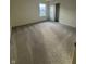 Well lit bedroom features plush carpet, large windows, and closet with sliding doors at 11015 Walter Dr, Indianapolis, IN 46235