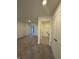 Bedroom showcasing neutral carpet and a view into the laundry room at 11015 Walter Dr, Indianapolis, IN 46235
