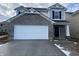 Charming two-story home featuring a brick facade, attached garage, and well-maintained landscaping at 11015 Walter Dr, Indianapolis, IN 46235