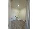 Functional laundry room with wood-look vinyl flooring and wire shelving at 11015 Walter Dr, Indianapolis, IN 46235