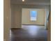 Bright living room with hardwood floors, large windows, and neutral wall color at 11015 Walter Dr, Indianapolis, IN 46235
