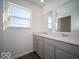 This bathroom has gray cabinets, double sinks, and large mirrors at 140 Velvet Hat Rd, Danville, IN 46122