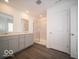 Modern bathroom with double vanity, glass shower and wood look flooring, offers a spa-like experience at 140 Velvet Hat Rd, Danville, IN 46122