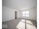 A sunny bedroom boasts a large window and plush carpeting for added comfort and style at 140 Velvet Hat Rd, Danville, IN 46122
