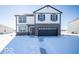 Two-story home with a two-car garage and a layer of snow on the ground at 140 Velvet Hat Rd, Danville, IN 46122