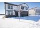 Two-story home with a two-car garage and a light layer of snow on the ground at 140 Velvet Hat Rd, Danville, IN 46122
