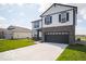 Two-story home with a large driveway leading to a two-car garage and a well-maintained lawn at 140 Velvet Hat Rd, Danville, IN 46122