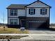 Two-story home with a two-car garage and a well-manicured lawn on a sunny day at 140 Velvet Hat Rd, Danville, IN 46122