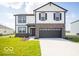 Charming two-story home with a two-car garage, brick accents, and a well-manicured lawn at 140 Velvet Hat Rd, Danville, IN 46122