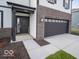 Close-up of the home's entry and garage, featuring a brick accent wall and a well-maintained lawn at 140 Velvet Hat Rd, Danville, IN 46122
