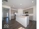 Modern kitchen with stainless steel appliances, island, and gray cabinetry at 140 Velvet Hat Rd, Danville, IN 46122