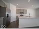 Well-lit kitchen with stainless steel refrigerator and modern island at 140 Velvet Hat Rd, Danville, IN 46122