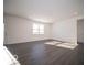 Interior view of a large living room with gray wood floors and natural lighting during the day at 140 Velvet Hat Rd, Danville, IN 46122