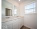 A modern bathroom with double sinks, white cabinets, and a large window for natural light at 146 Velvet Hat Rd, Danville, IN 46122