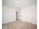 A bedroom with neutral carpet and a closet is enhanced by white walls at 146 Velvet Hat Rd, Danville, IN 46122