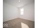 Cozy bedroom with neutral carpet, large window, and neutral-painted walls at 146 Velvet Hat Rd, Danville, IN 46122