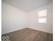 Cozy bedroom with luxury vinyl plank flooring and a bright window at 146 Velvet Hat Rd, Danville, IN 46122