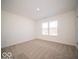 A spacious, light-filled bedroom features a large window and neutral carpeting at 146 Velvet Hat Rd, Danville, IN 46122