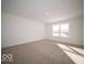 Bright bedroom featuring a large window and neutral carpet at 146 Velvet Hat Rd, Danville, IN 46122