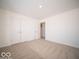A bedroom with neutral carpet and a closet is enhanced by white walls at 146 Velvet Hat Rd, Danville, IN 46122