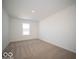 Bright bedroom with a large window, neutral carpet, and white walls at 146 Velvet Hat Rd, Danville, IN 46122