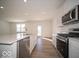 Spacious kitchen with quartz counters, stainless appliances, and an open-concept layout at 146 Velvet Hat Rd, Danville, IN 46122