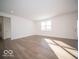 Open-concept living room with luxury vinyl plank flooring and abundant natural light at 146 Velvet Hat Rd, Danville, IN 46122