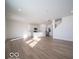 Open-concept living room and kitchen with hardwood floors and stainless steel appliances at 146 Velvet Hat Rd, Danville, IN 46122