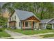 Craftsman style home with a custom wood porch, inviting curb appeal, and mature trees at 6129 Crittenden Ave, Indianapolis, IN 46220