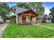 Charming two-story home with a covered front porch and manicured lawn at 6129 Crittenden Ave, Indianapolis, IN 46220