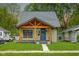 Charming home featuring a custom wood porch, beautiful lawn and inviting curb appeal at 6129 Crittenden Ave, Indianapolis, IN 46220