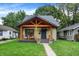 Beautiful single-story home featuring a covered front porch and lush green lawn at 6129 Crittenden Ave, Indianapolis, IN 46220